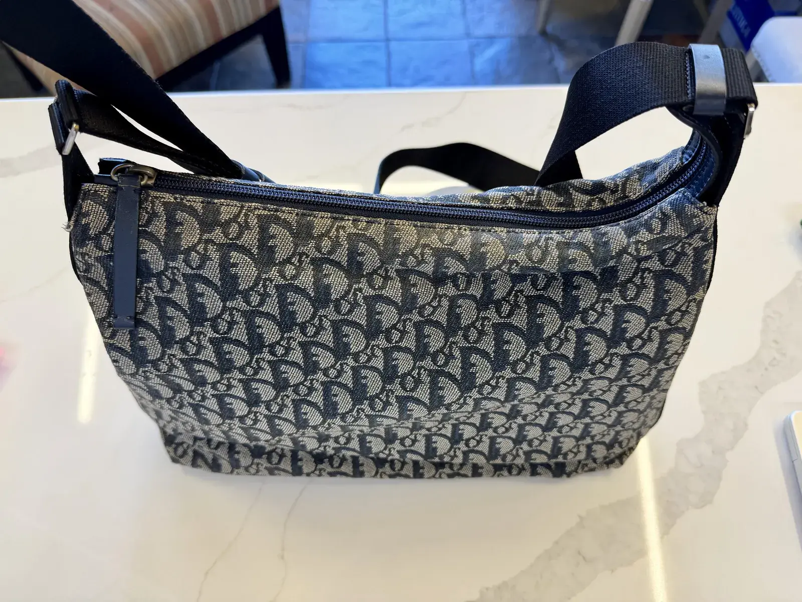 The same vintage Dior Trotter canvas messenger bag after cleaning at Baroni Cleaners Irvine, the navy Oblique jacquard even from the zipper to the base with the ecru weave bright again