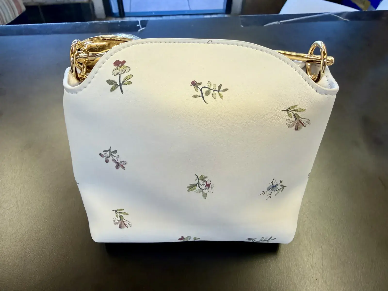 The same Erdem Mini Bloom tote after ink removal and color matching at Baroni Cleaners Irvine, front panel back to uniform porcelain white