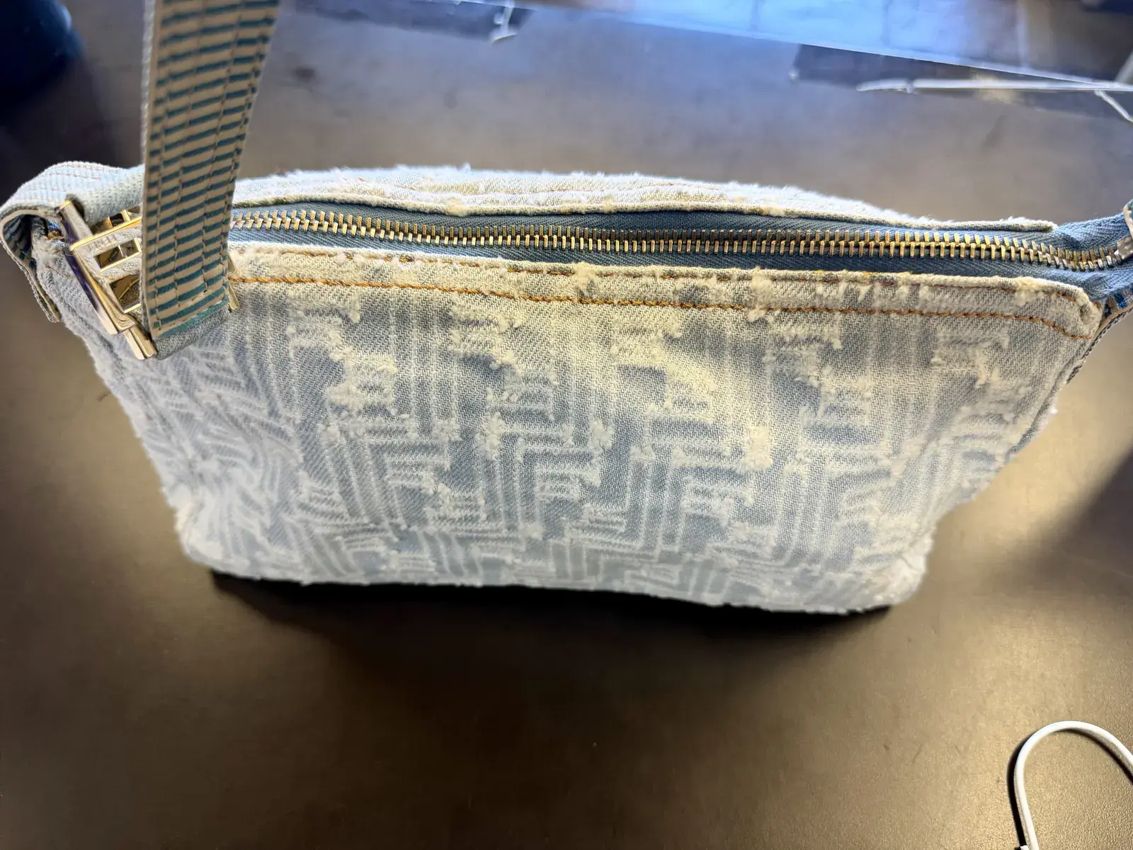 Second angle of the finished Fendi denim bag at Baroni Cleaners, pale blue denim and cream FF pile uniform across the whole panel