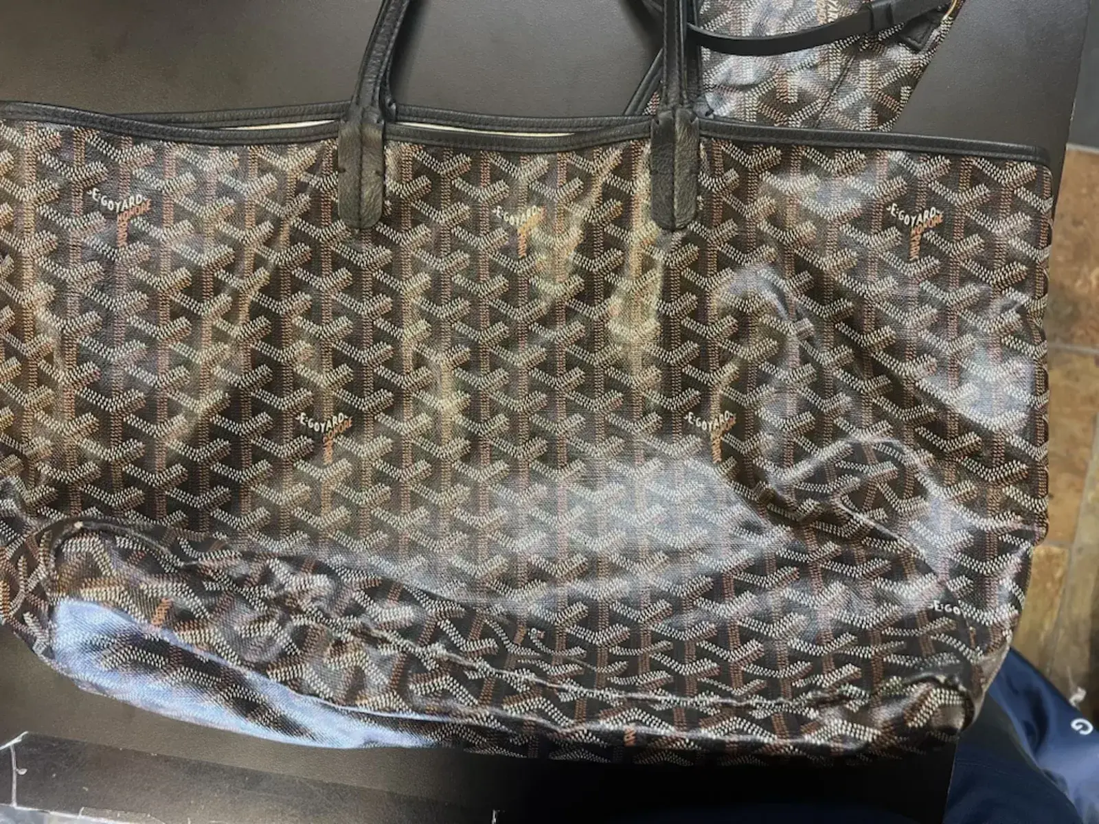 Goyard Saint Louis exterior before cleaning, a chalky grey film dulling the black and tan chevron canvas