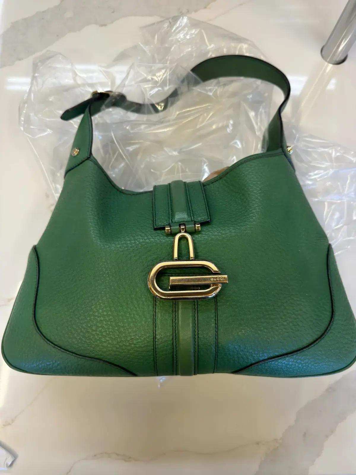 The same early 2000s Gucci Piston Lock Jackie after cleaning at Baroni Cleaners Irvine, green pebbled leather one even tone around the gold G piston lock