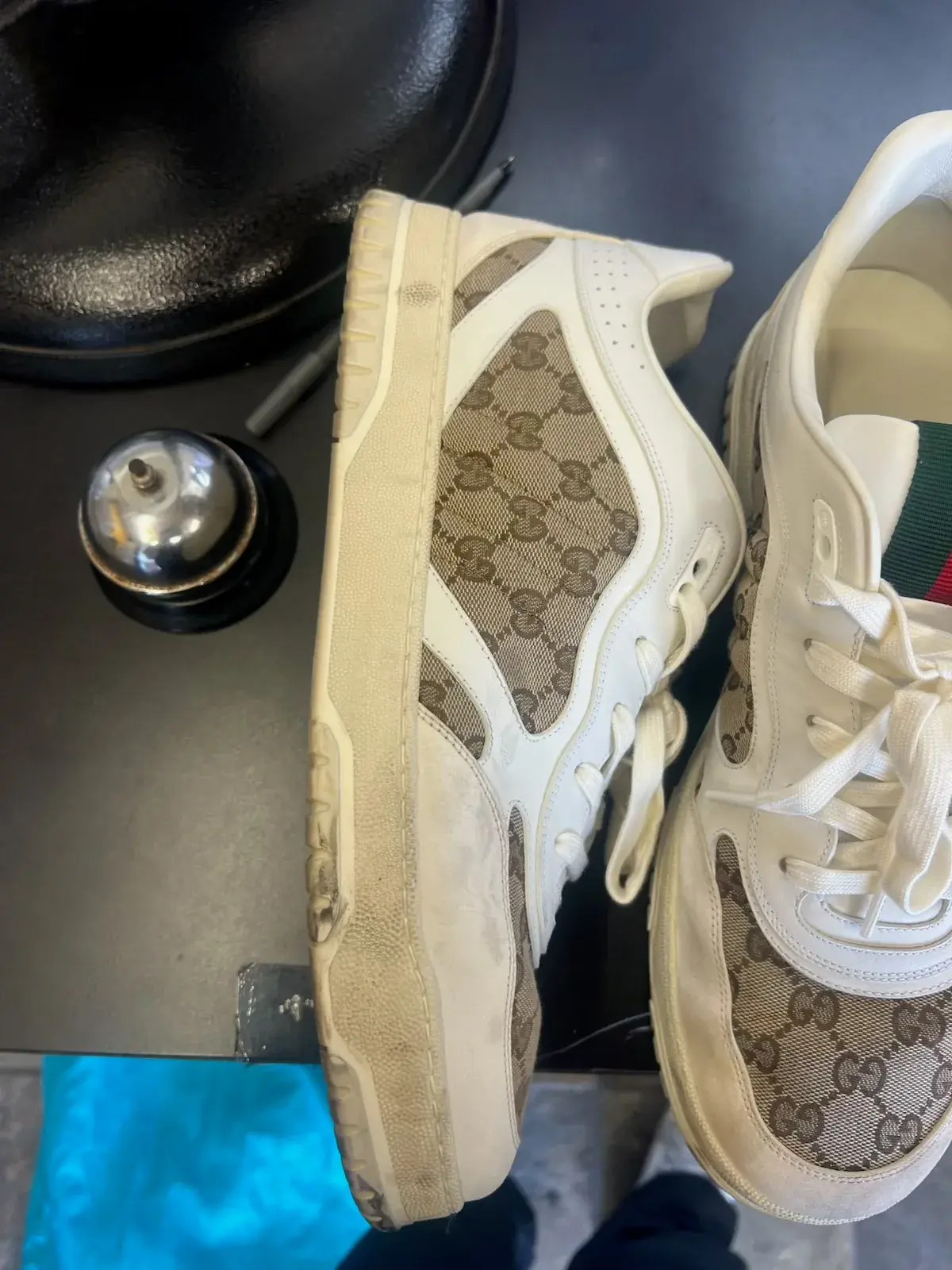 Side view of a worn Gucci GG monogram sneaker before deep cleaning at Baroni Cleaners Irvine
