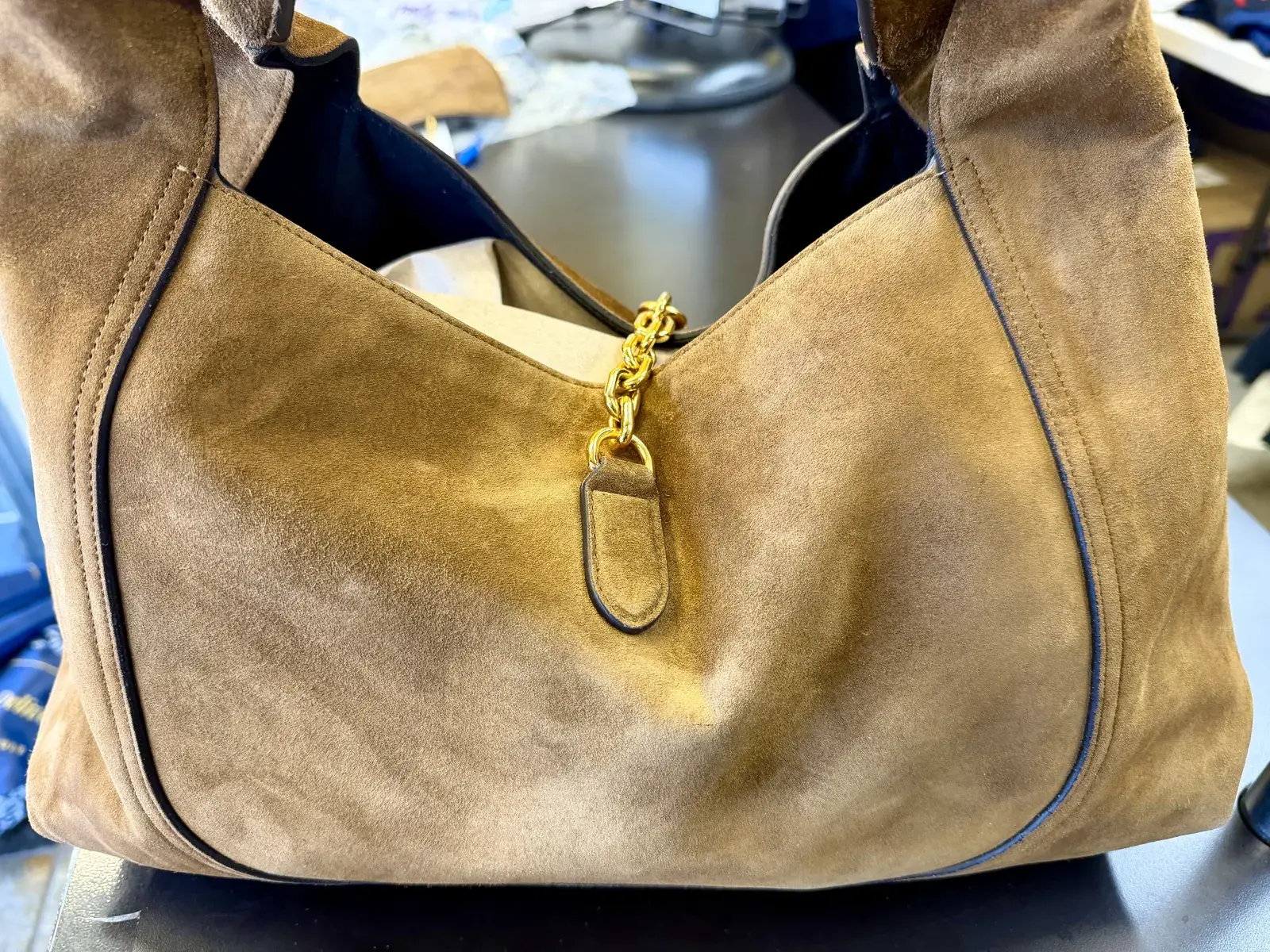 Back of the cleaned Gucci suede hobo with its gold chain and suede tab, the blotchy oil marks across the lower panel gone and the nap uniform