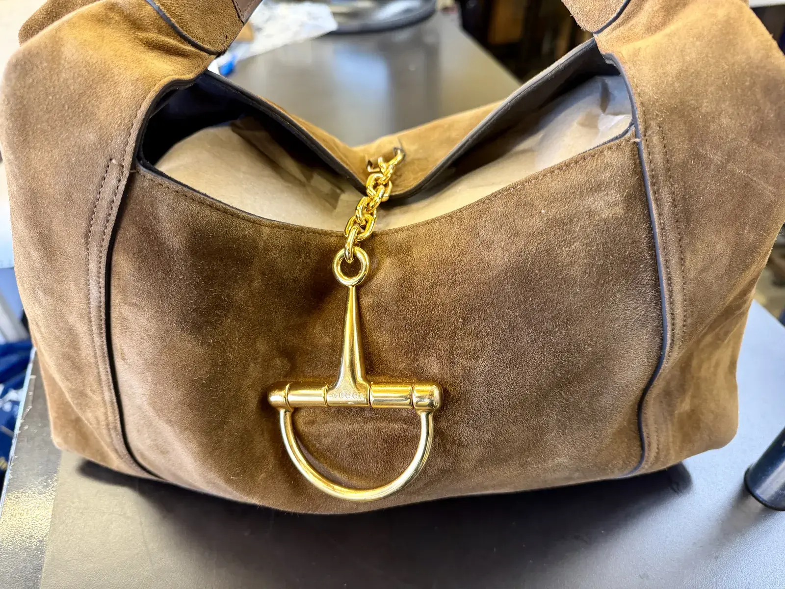 The same Gucci brown suede hobo after oil stain removal at Baroni Cleaners Irvine, the front panel one even brown around the polished gold horsebit