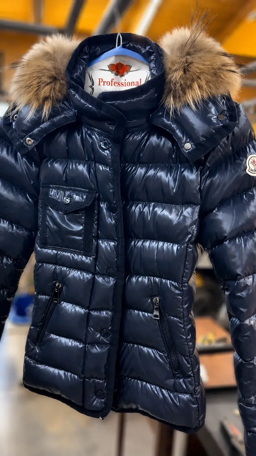 Navy Moncler Armoise down jacket with raccoon fur hood after professional cleaning at Baroni Cleaners Irvine