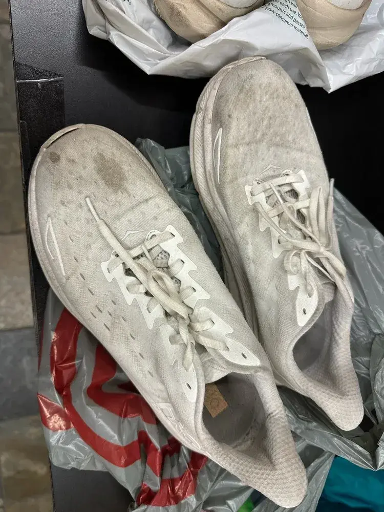 Dirty stained running shoes before professional cleaning