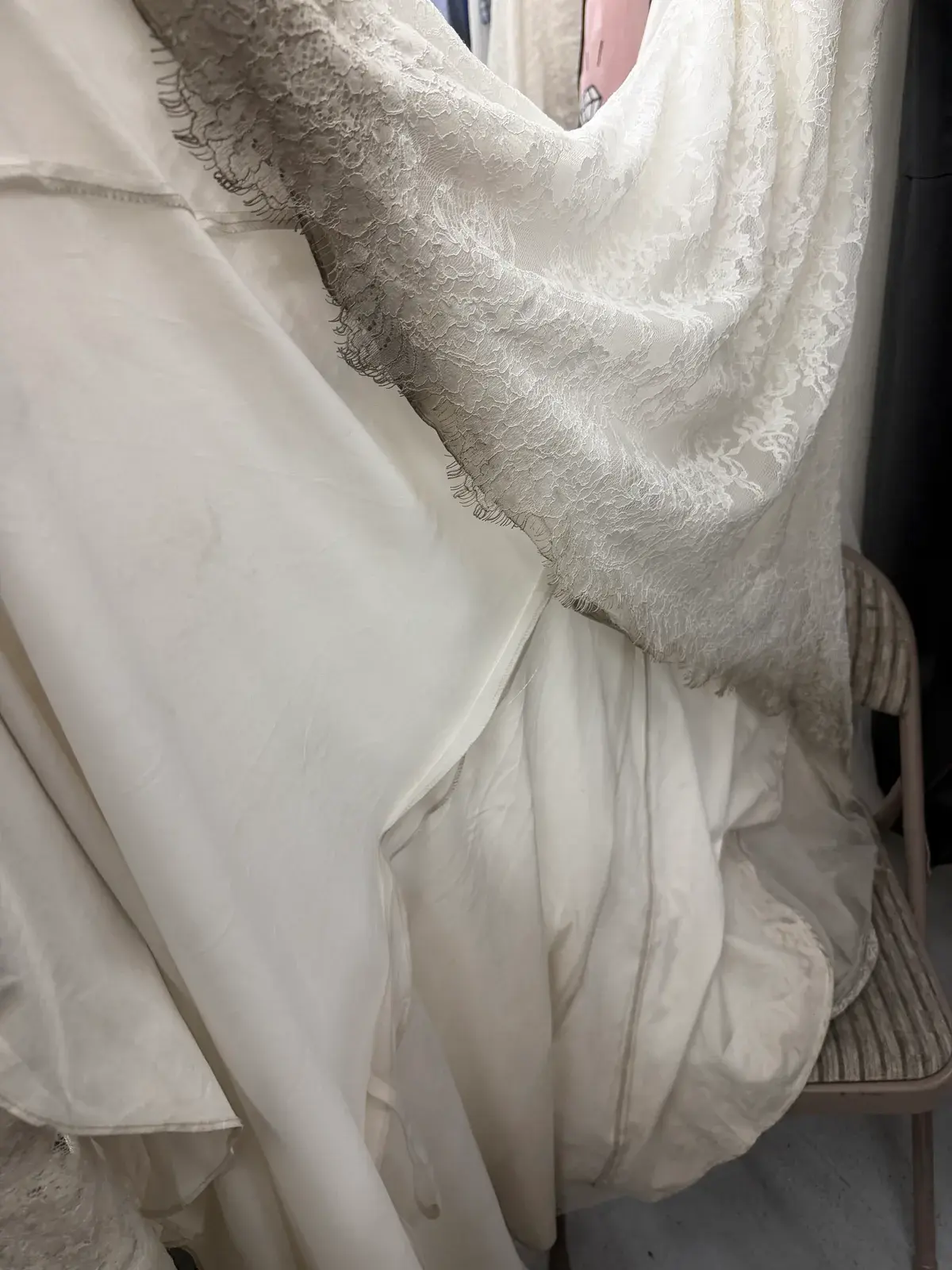 Dirt ground into the train and lace edge of a wedding gown before professional cleaning at Baroni Cleaners Irvine