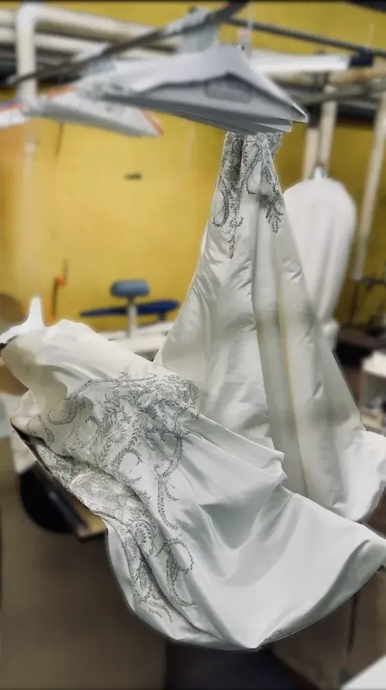 Beaded wedding gown hanging after professional cleaning at Baroni Cleaners Irvine