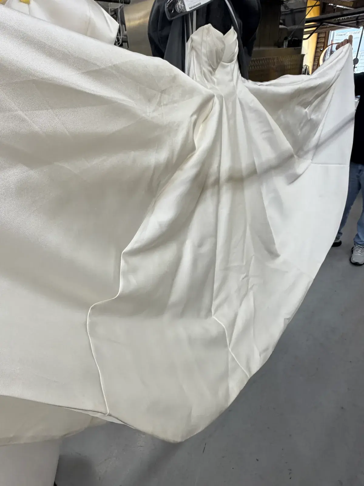 Large stains across the satin train of a wedding gown before cleaning at Baroni Cleaners Irvine