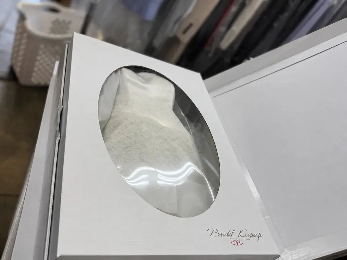 Sealed Bridal Keepsafe preservation box with display window showing the cleaned wedding gown at Baroni Cleaners Irvine